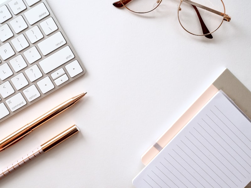 Notebook with content strategy notes and a laptop showing website copy being written