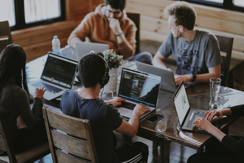 Web development team collaborating on a project in modern office