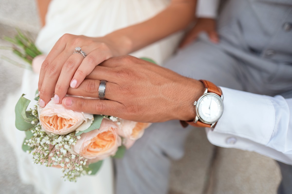 Couple reviewing wedding details with their planner at a stylish venue
